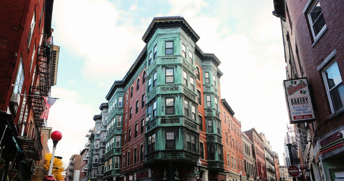 Charming street corner with vintage buildings in a bustling city scene.