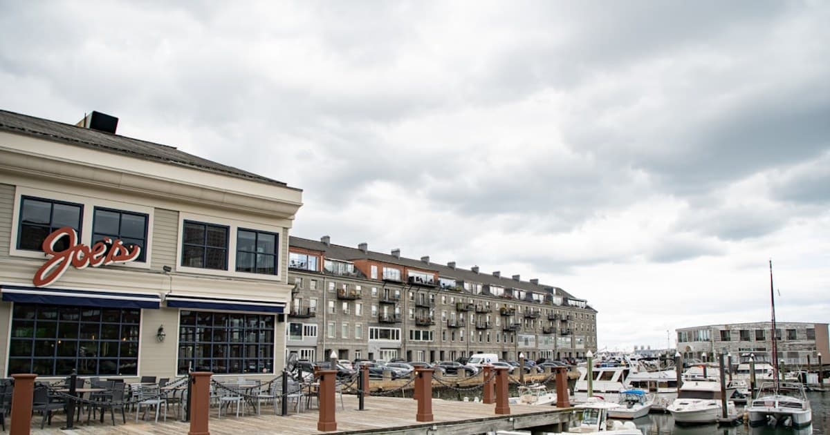 a dock with a restaurant and boats in the water