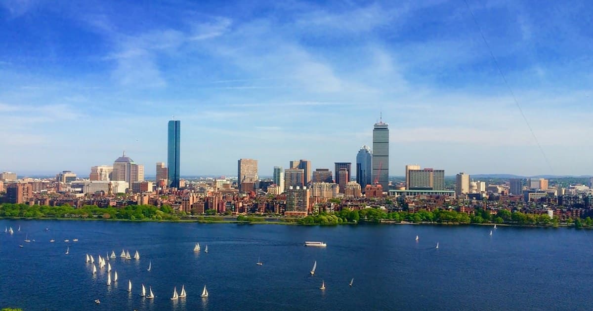 body of water near cityscape at daytime