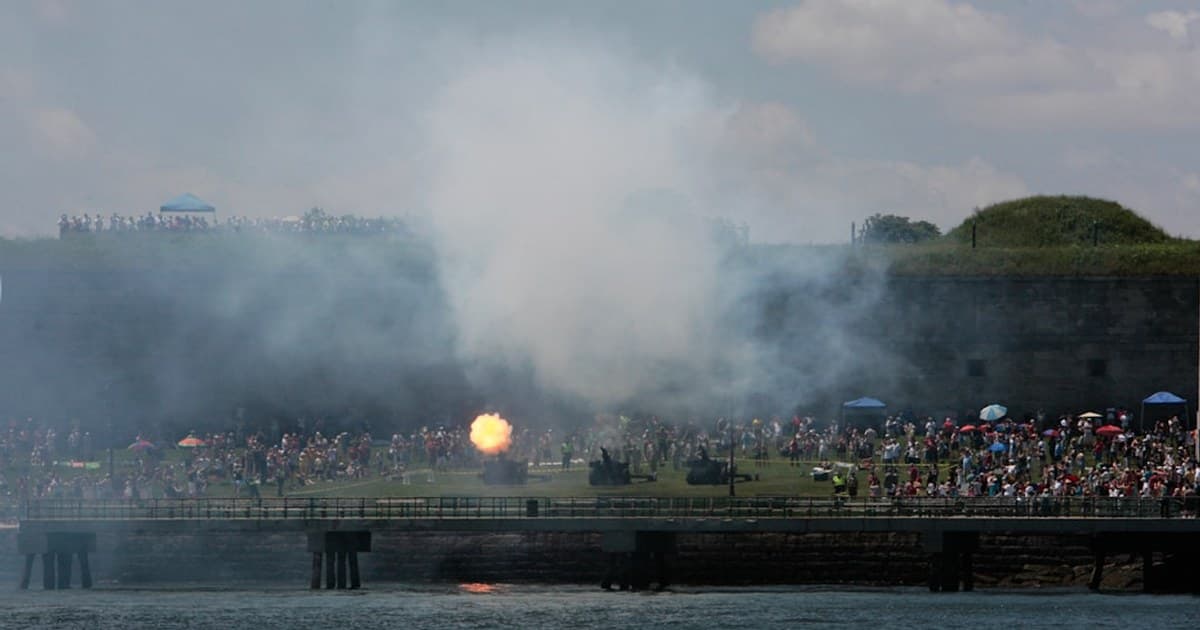 a large crowd of people watching a concert on a pier