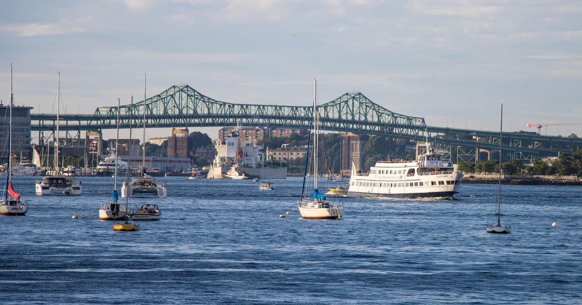 Scenic view of boats on Mystic River with Charlestown Bridge in Boston.